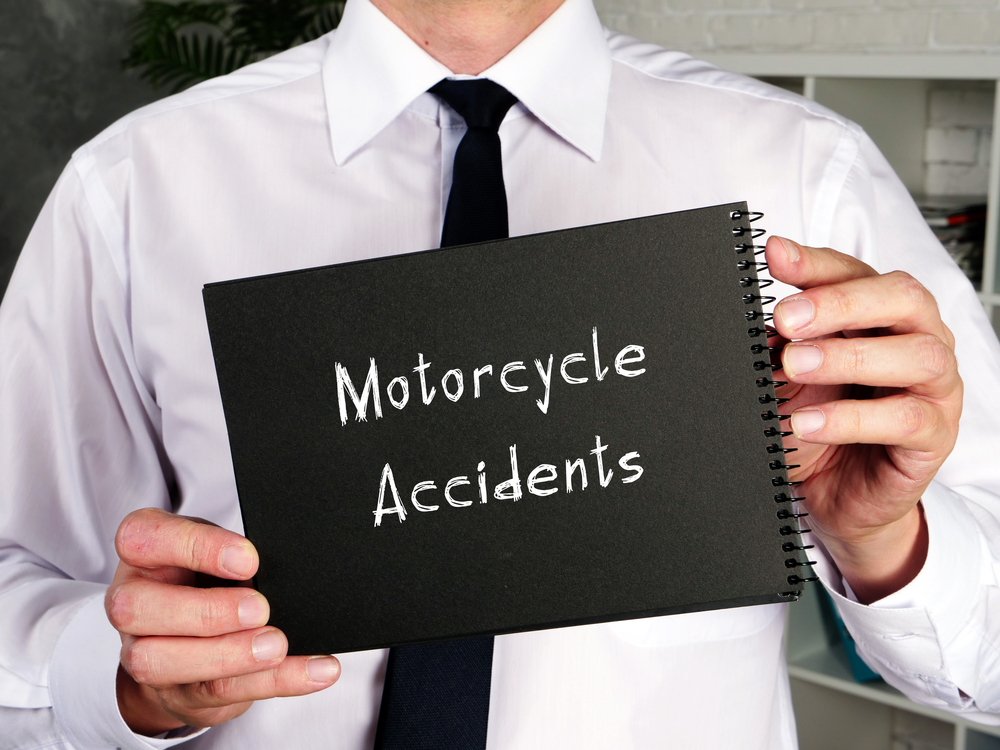 lawyer holding a sign that represents motorcycle accidents