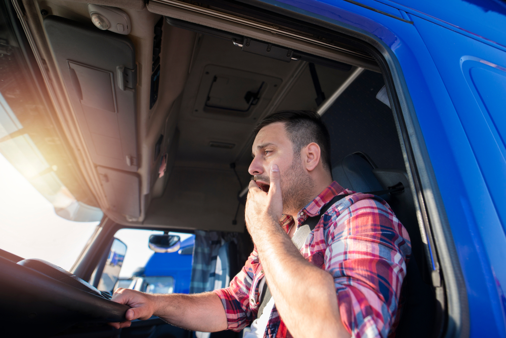 truck driver yawning while doing a delivery in Mississippi